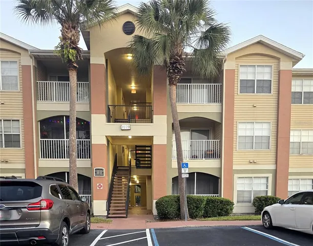 a front view of a residential apartment building with a yard
