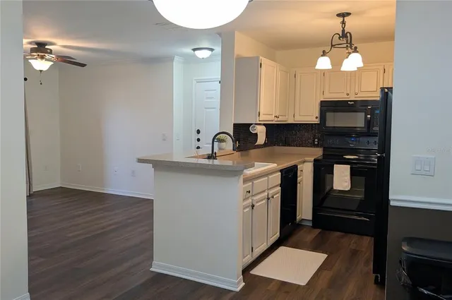 a kitchen with a sink and a stove top oven