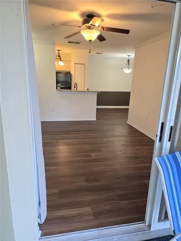 a kitchen with stainless steel appliances granite countertop a refrigerator a stove and a sink with wooden floor