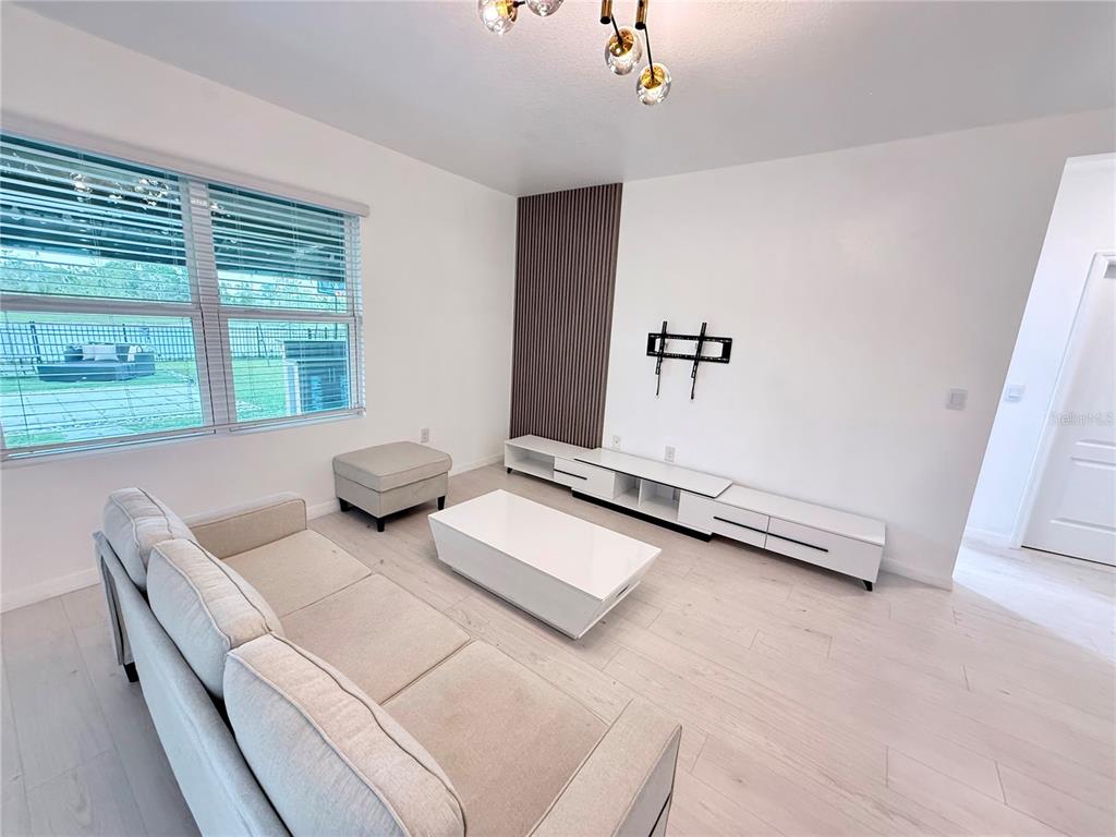 2731 House Finch Road Harmony, FL 34773 - Photo 12 of 57 a living room with furniture and a window