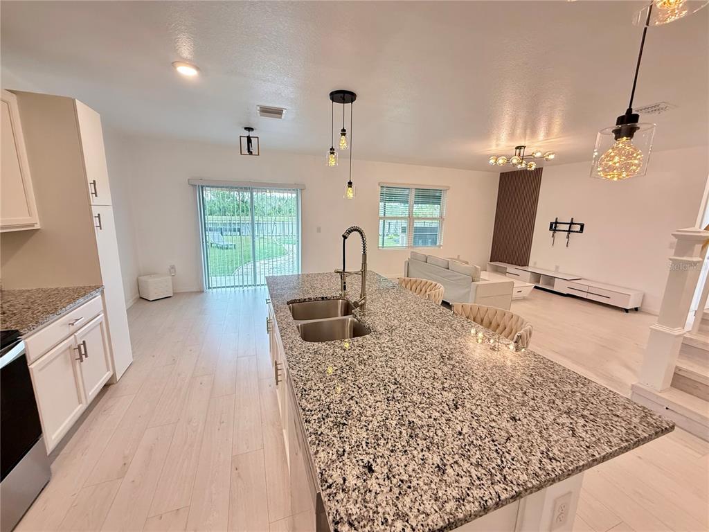 2731 House Finch Road Harmony, FL 34773 - Photo 19 of 57 a kitchen with sink refrigerator and window