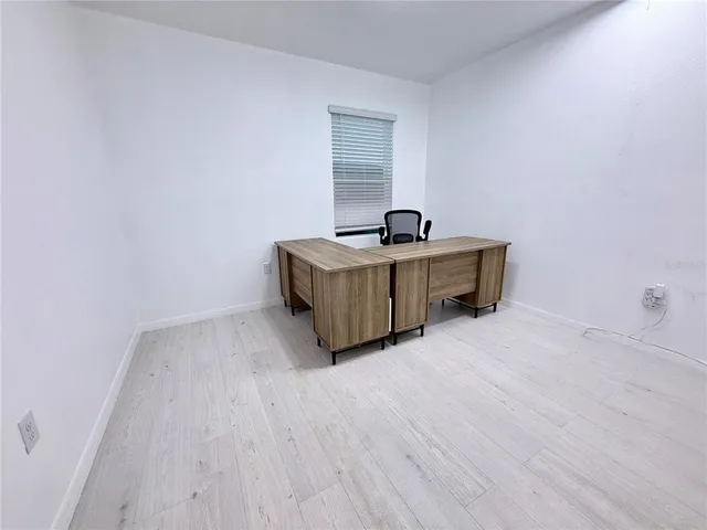 a room with a sink and a refrigerator