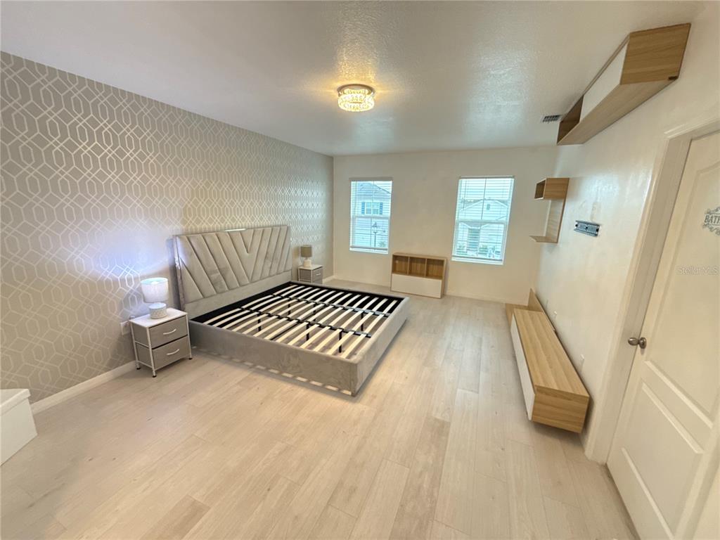 2731 House Finch Road Harmony, FL 34773 - Photo 31 of 57 a view of wooden floor and windows in a room