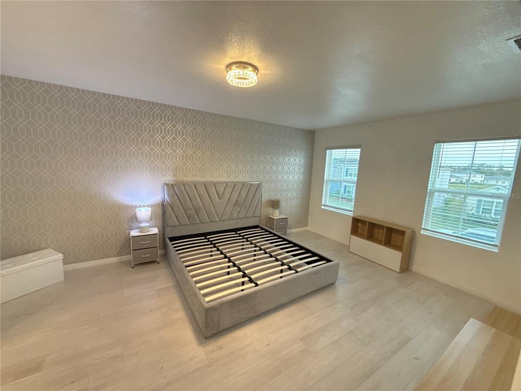 2731 House Finch Road Harmony, FL 34773 - Photo 34 of 57 a bedroom with furniture and window