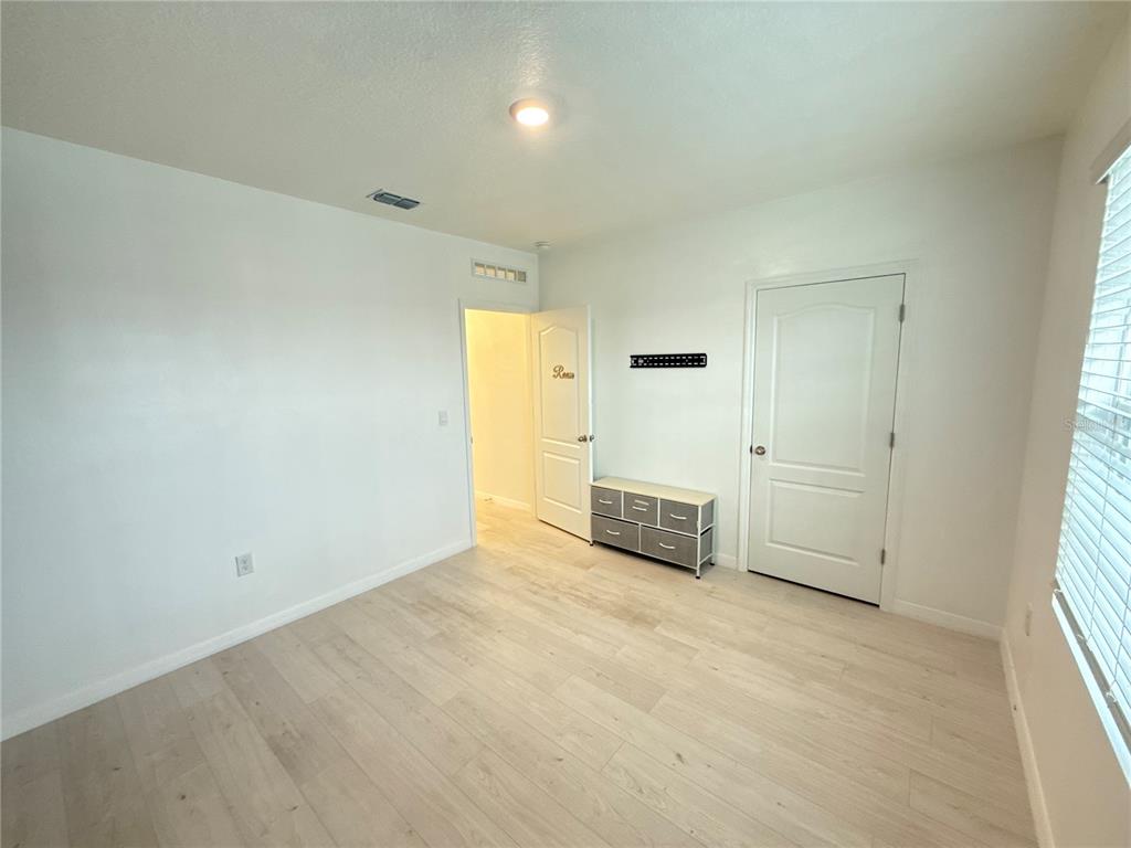 2731 House Finch Road Harmony, FL 34773 - Photo 44 of 57 an empty room with a kitchen