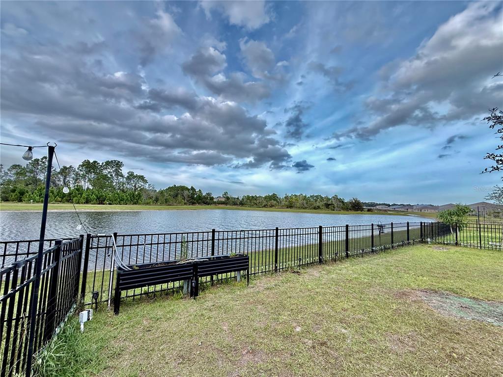 2731 House Finch Road Harmony, FL 34773 - Photo 51 of 57 a view of a bench in the middle of a lake