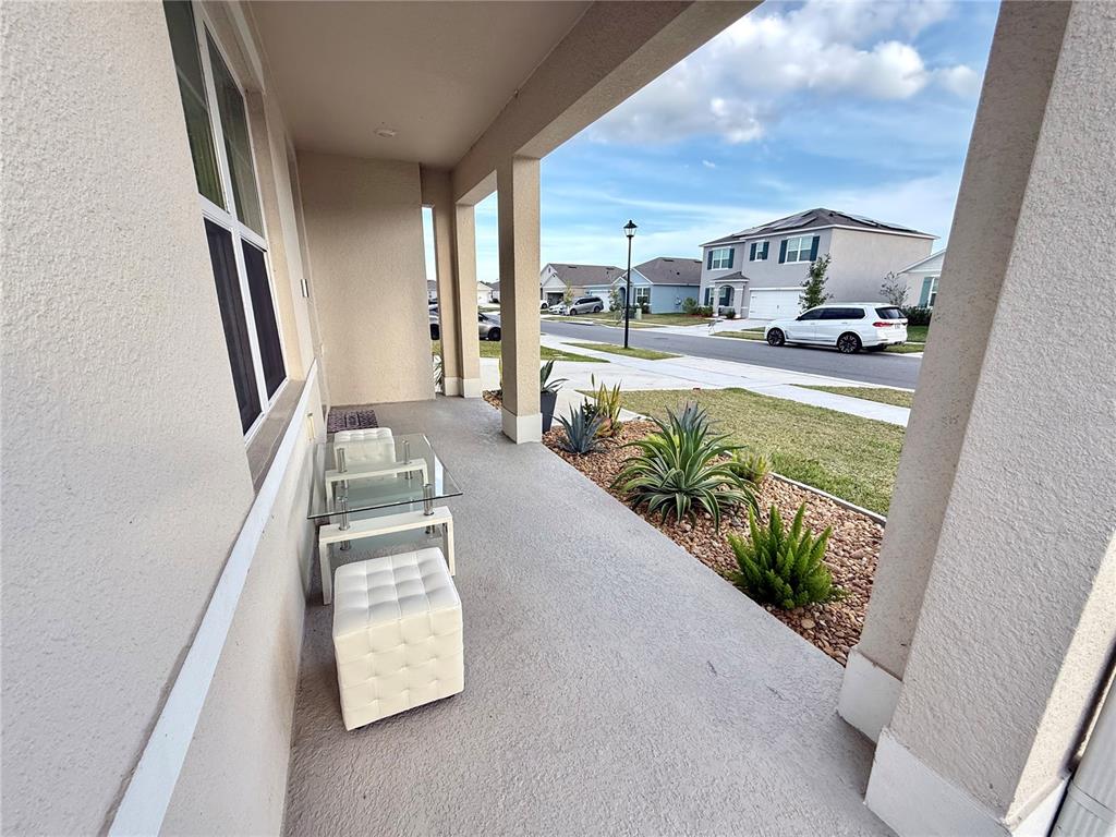 2731 House Finch Road Harmony, FL 34773 - Photo 7 of 57 a view of living room with furniture and a floor to ceiling window