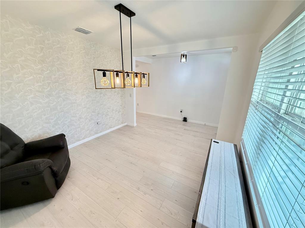 2731 House Finch Road Harmony, FL 34773 - Photo 9 of 57 a view of empty room with windows