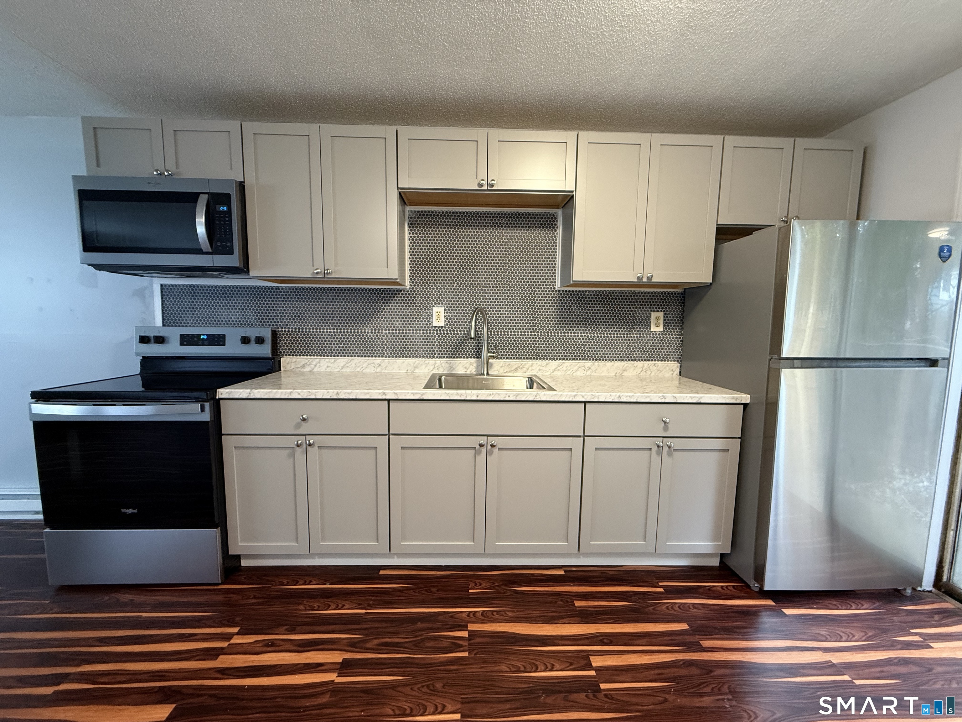 76 Summer Street, Unit 4 New London, CT 06320 - Photo 1 of 9 a kitchen with a sink and a refrigerator
