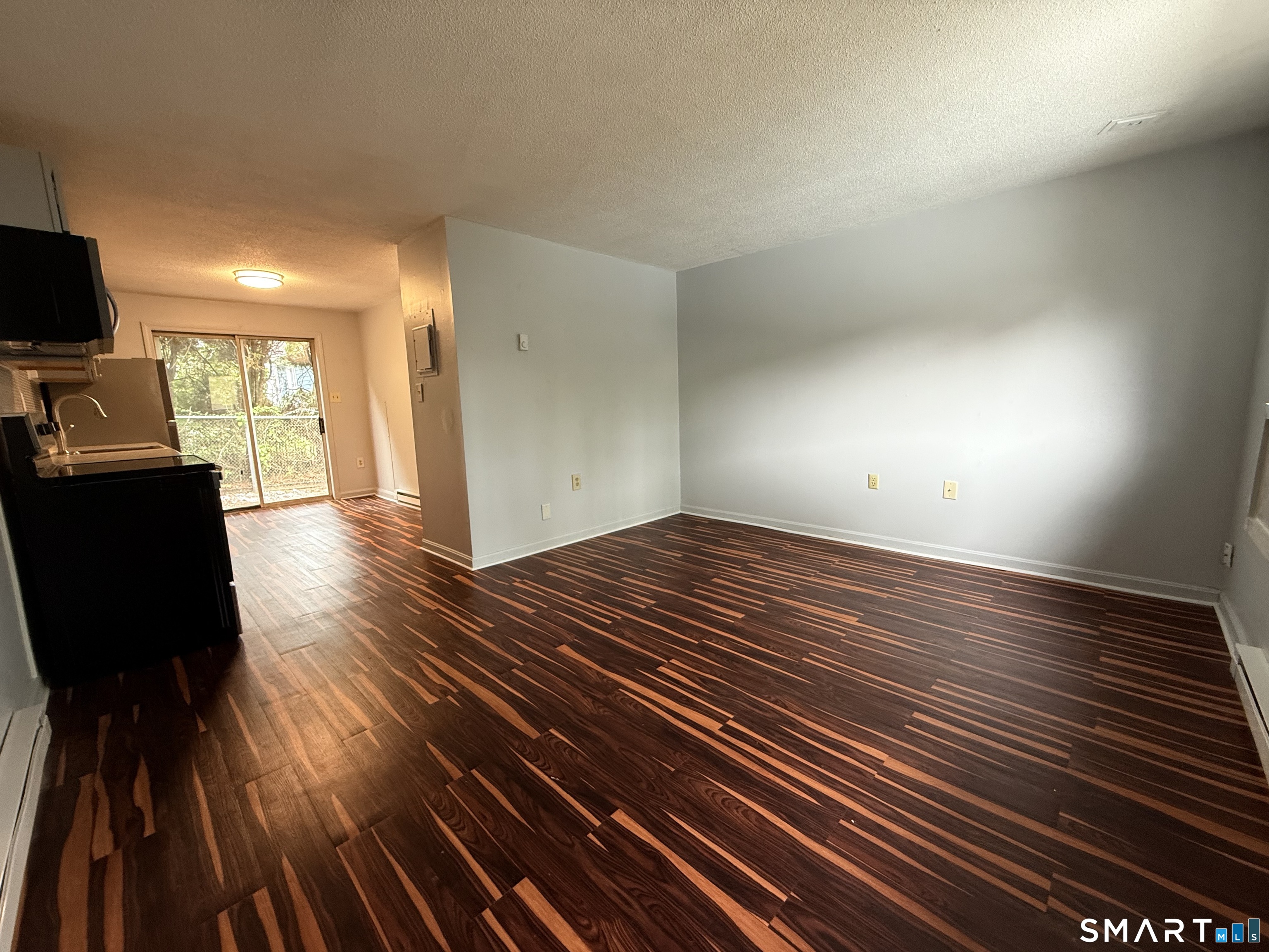 76 Summer Street, Unit 4 New London, CT 06320 - Photo 4 of 9 a view of a room with wooden floor and furniture