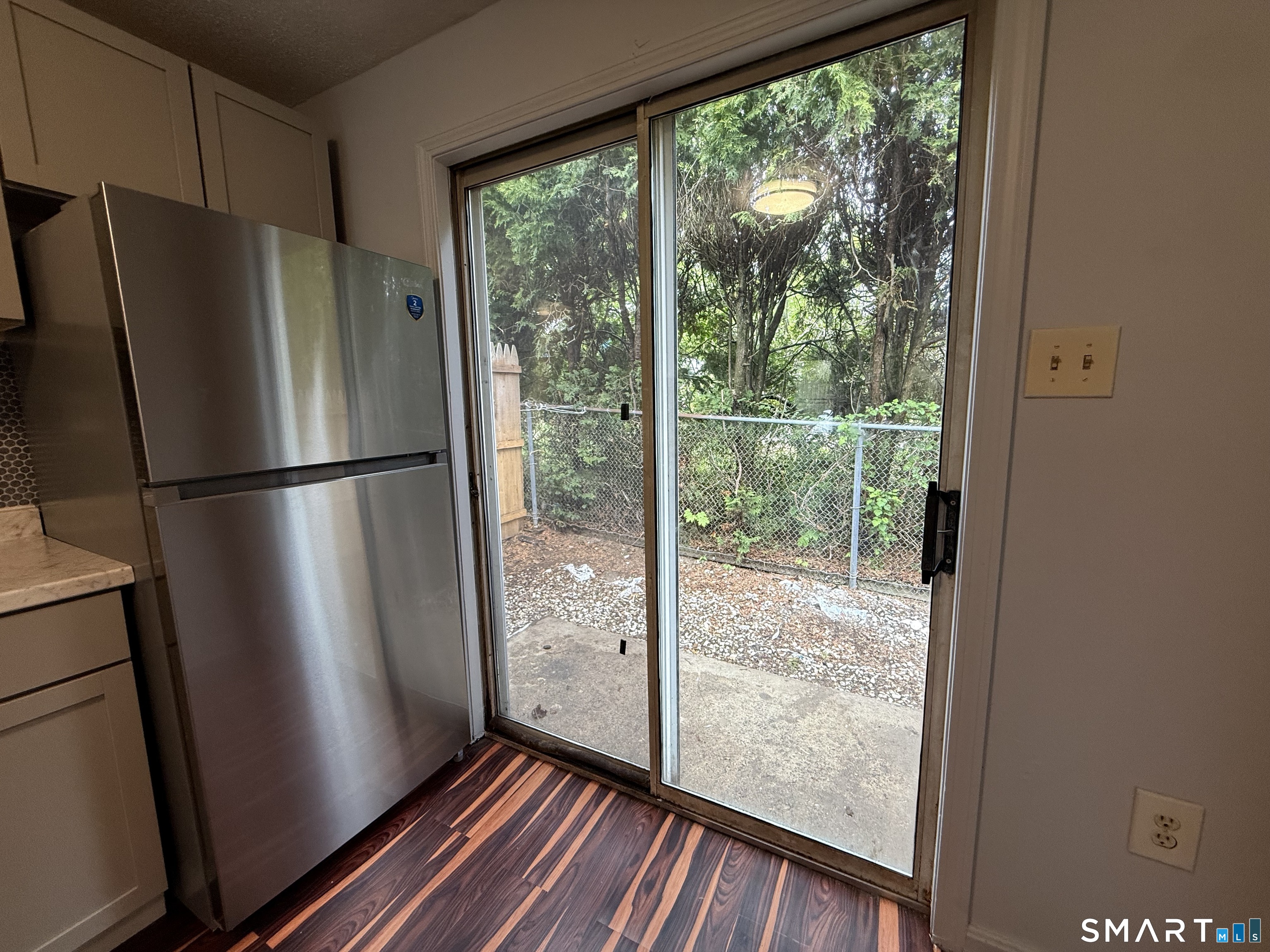 76 Summer Street, Unit 4 New London, CT 06320 - Photo 5 of 9 a view of a glass door and wooden floor