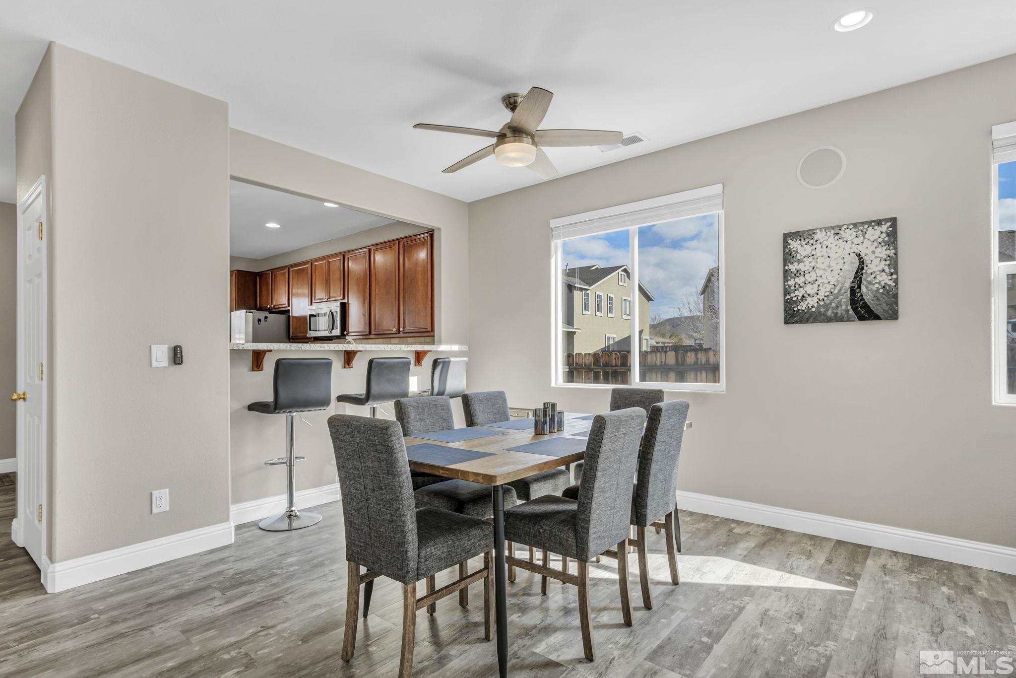 2296 Rio Lobo Lane Reno, NV 89521 - Photo 11 of 33 a dining room with furniture a window and wooden floor