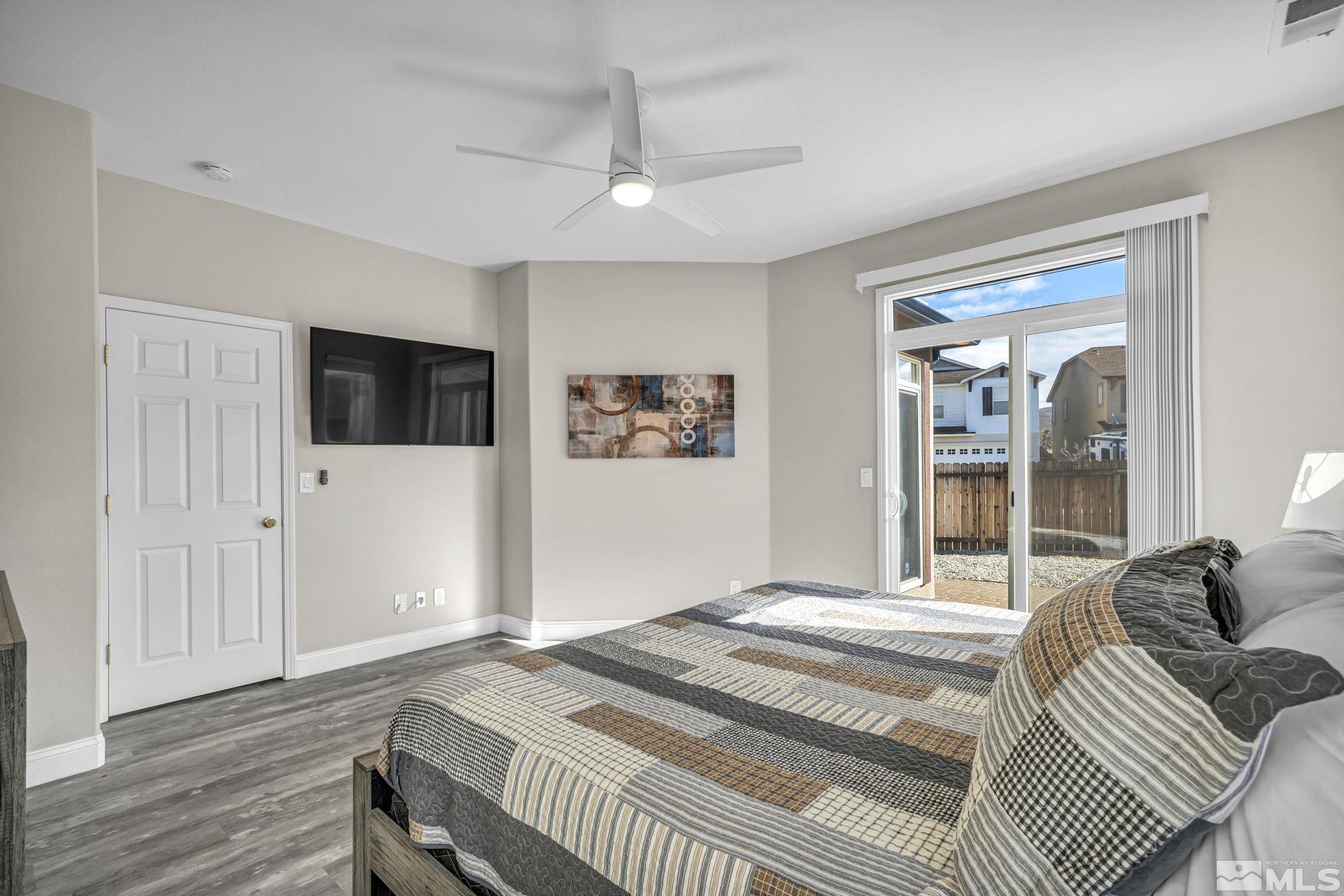 2296 Rio Lobo Lane Reno, NV 89521 - Photo 22 of 33 a bedroom with a large bed a flat tv screen and a dresser