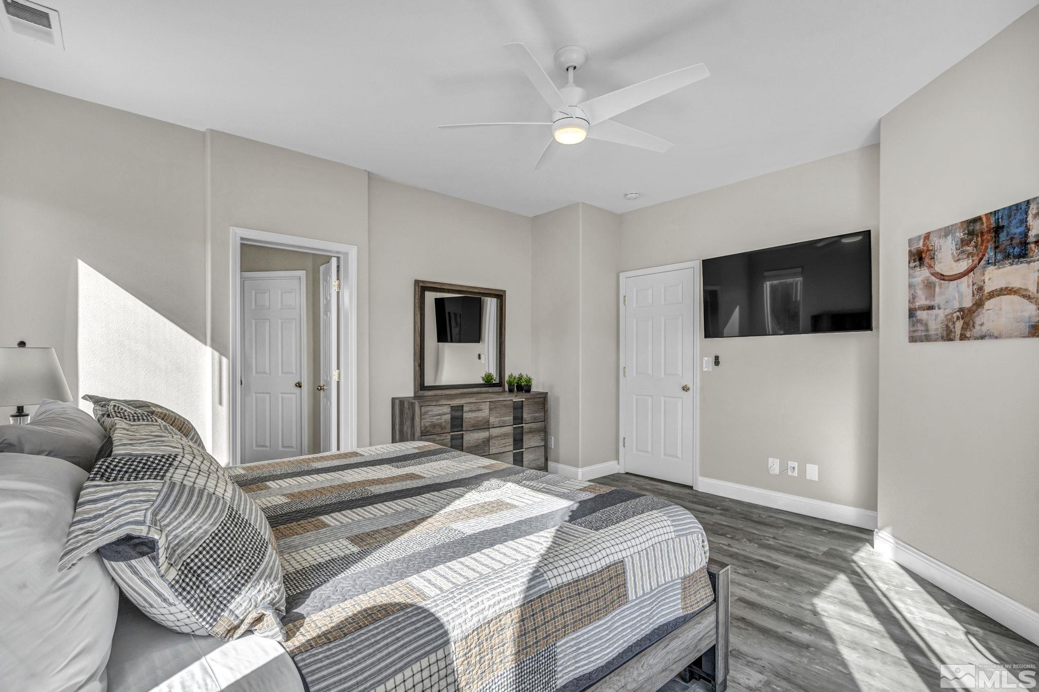 2296 Rio Lobo Lane Reno, NV 89521 - Photo 23 of 33 a bedroom with a bed and a flat screen tv