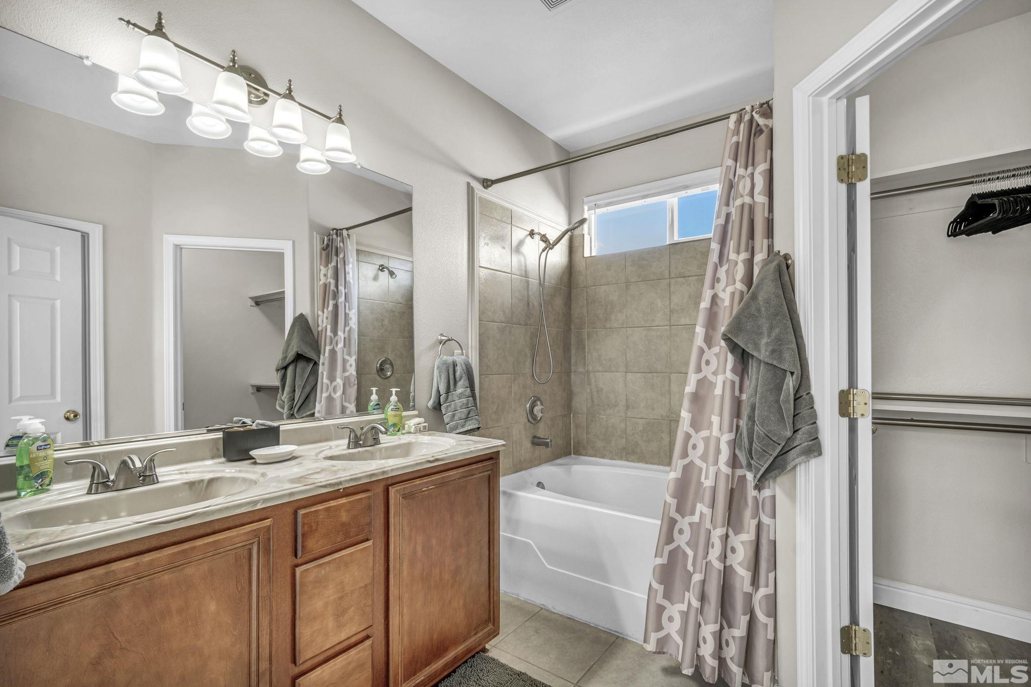 2296 Rio Lobo Lane Reno, NV 89521 - Photo 24 of 33 a bathroom with a double vanity sink mirror and shower