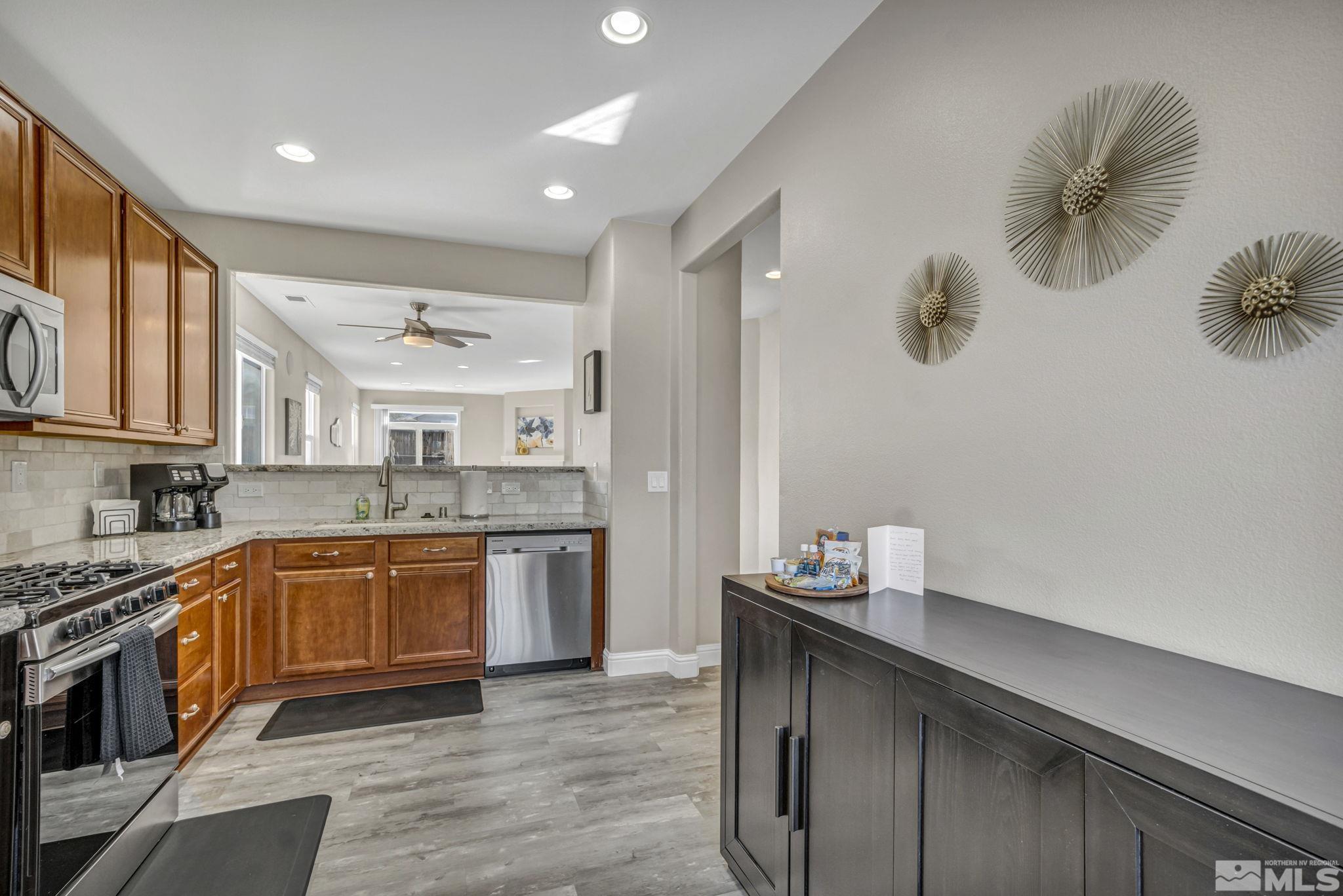 2296 Rio Lobo Lane Reno, NV 89521 - Photo 6 of 33 a kitchen with granite countertop cabinets a sink and stainless steel appliances
