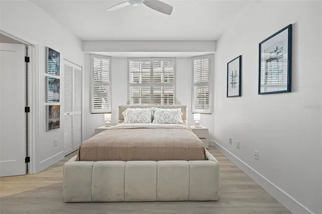 a bedroom with a bed and glass window