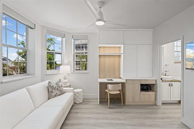 a living room with furniture a fireplace and a large window