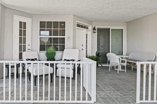 a view of a room with two chairs and table in a patio