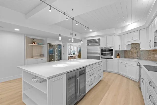 a kitchen with sink a stove and cabinets