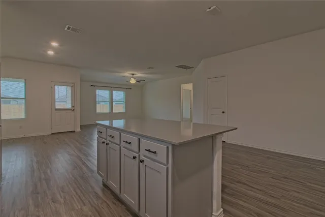 a kitchen with stainless steel appliances white cabinets sink and stove