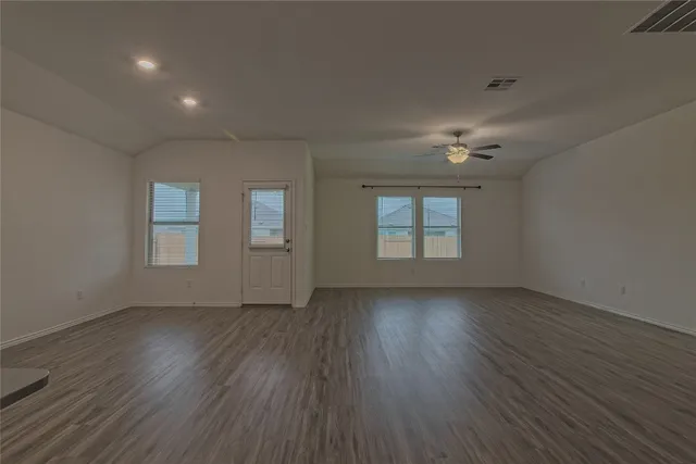 a view of a kitchen with cabinets and wooden floor