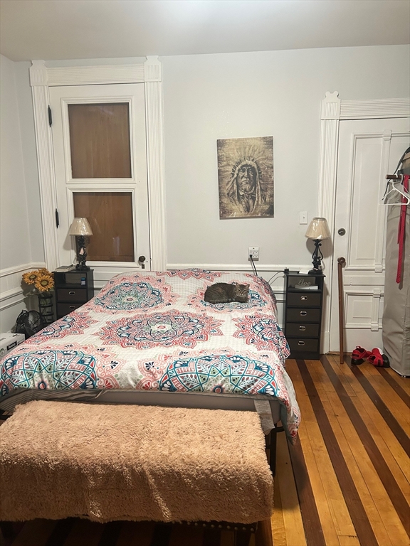 237 Branch Street Lowell, MA 01851 - Photo 11 of 15 a bedroom with a bed and a cabinets
