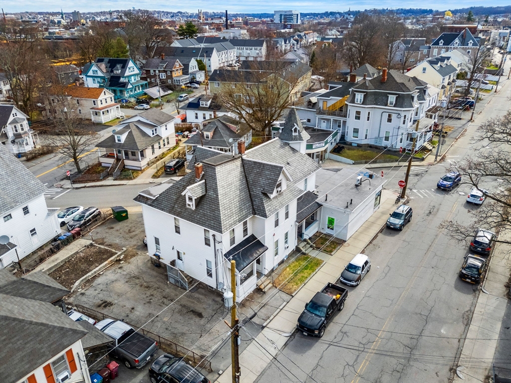 237 Branch Street Lowell, MA 01851 - Photo 3 of 15 an aerial view of a house with a lot of residential buildings ocean and mountain view in back