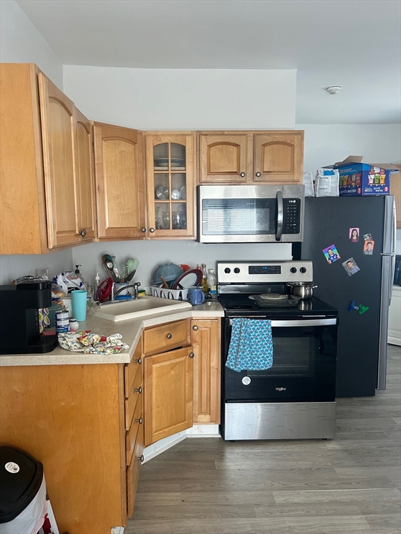 237 Branch Street Lowell, MA 01851 - Photo 6 of 15 a kitchen with stainless steel appliances granite countertop a stove a sink and a refrigerator