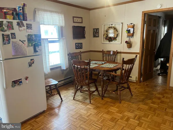 a kitchen with stainless steel appliances granite countertop a refrigerator a sink dishwasher and a stove with wooden floor