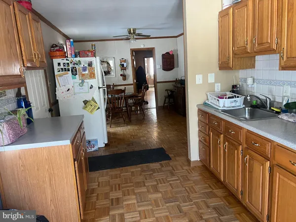 a kitchen with stainless steel appliances granite countertop a sink and a refrigerator