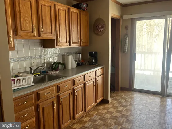 a kitchen with stainless steel appliances granite countertop a refrigerator a sink a stove and white cabinets
