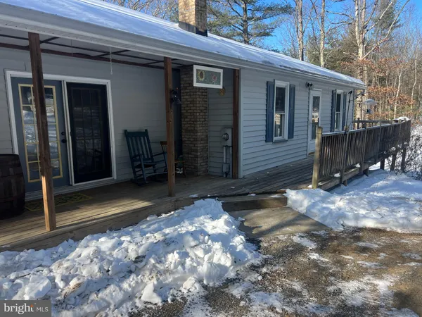 a view of a house with backyard and porch
