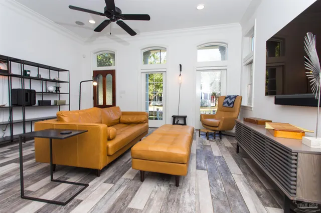 a living room with furniture and a wooden floor
