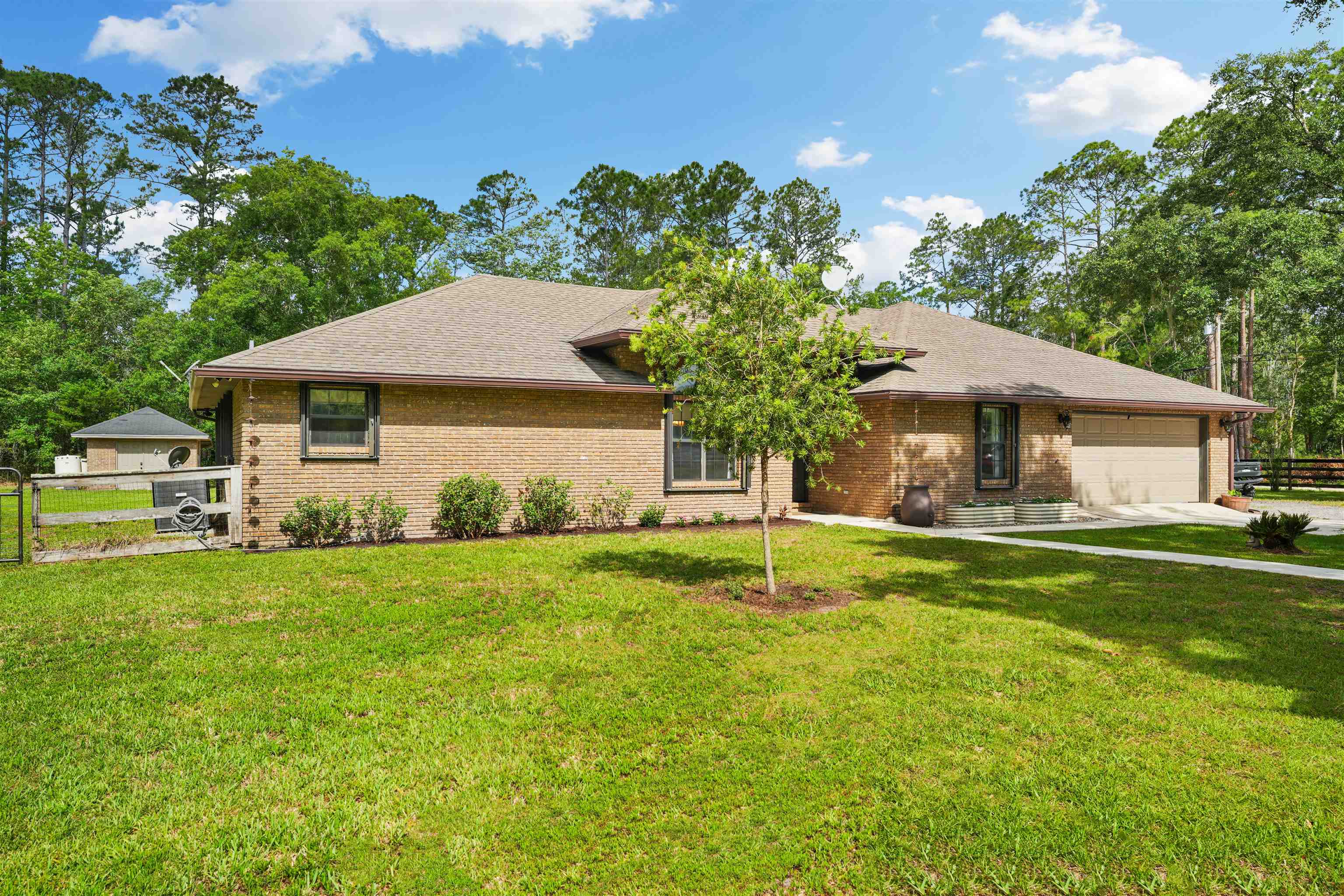 1805 Bennett Road St. Augustine, FL 32092 - Photo 6 of 65 a front view of a house with a yard and trees