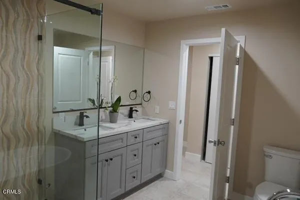 a bathroom with a double vanity sink and a mirror