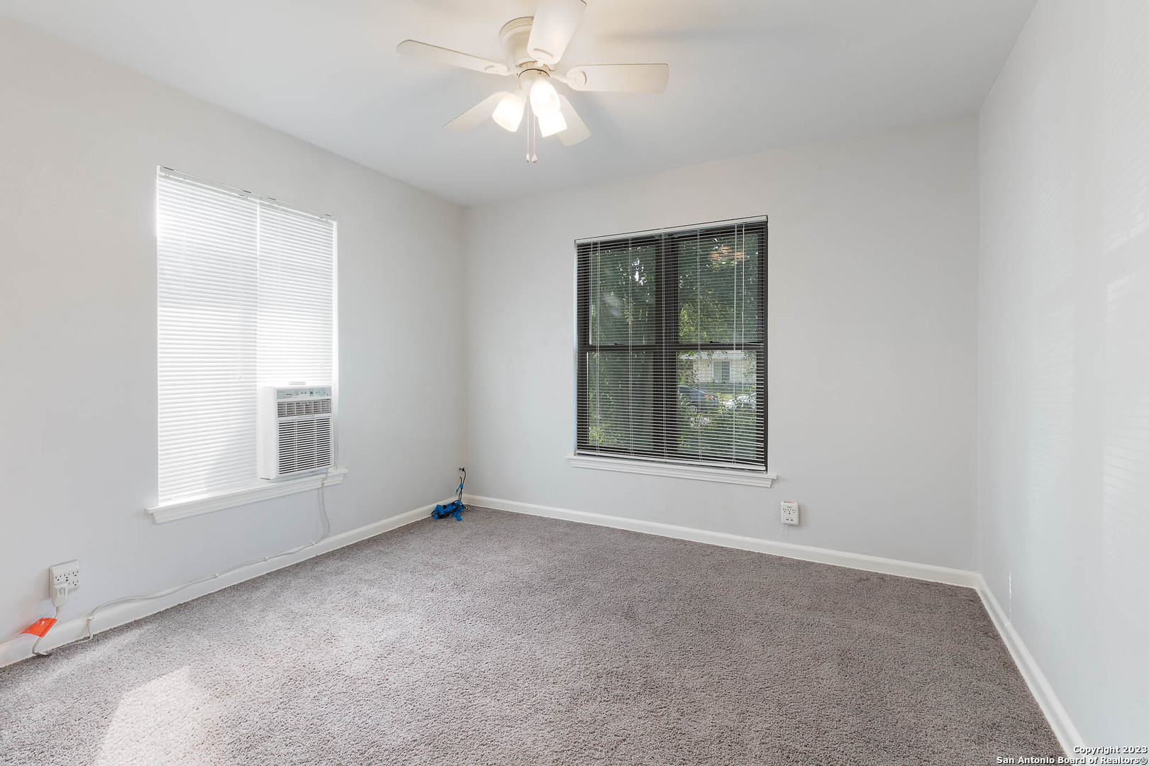 463 Cherry Ridge San Antonio, TX 78213 - Photo 16 of 19 an empty room with a window and a ceiling fan