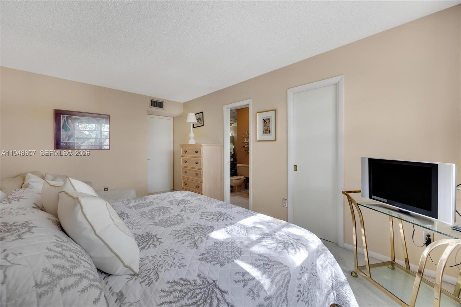 11769 Southwest 91st Terrace Miami, FL 33186 - Photo 16 of 33 a bedroom with a bed and a flat screen tv