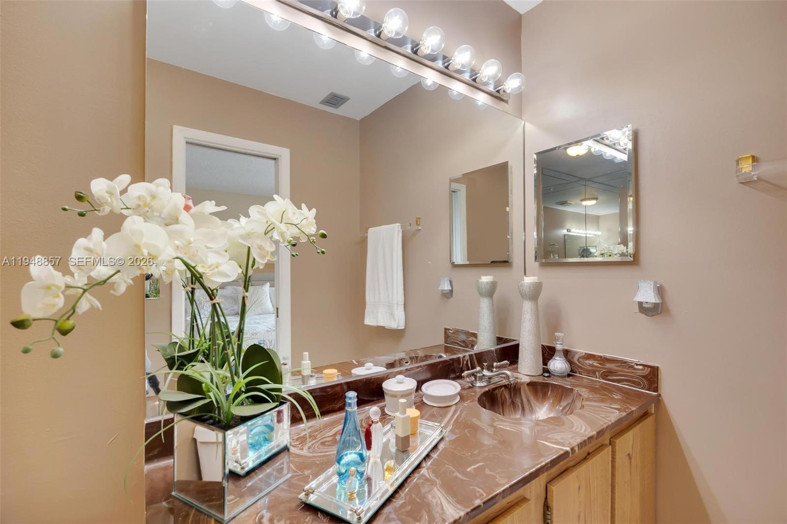11769 Southwest 91st Terrace Miami, FL 33186 - Photo 17 of 33 a bathroom with a sink a large mirror and vanity