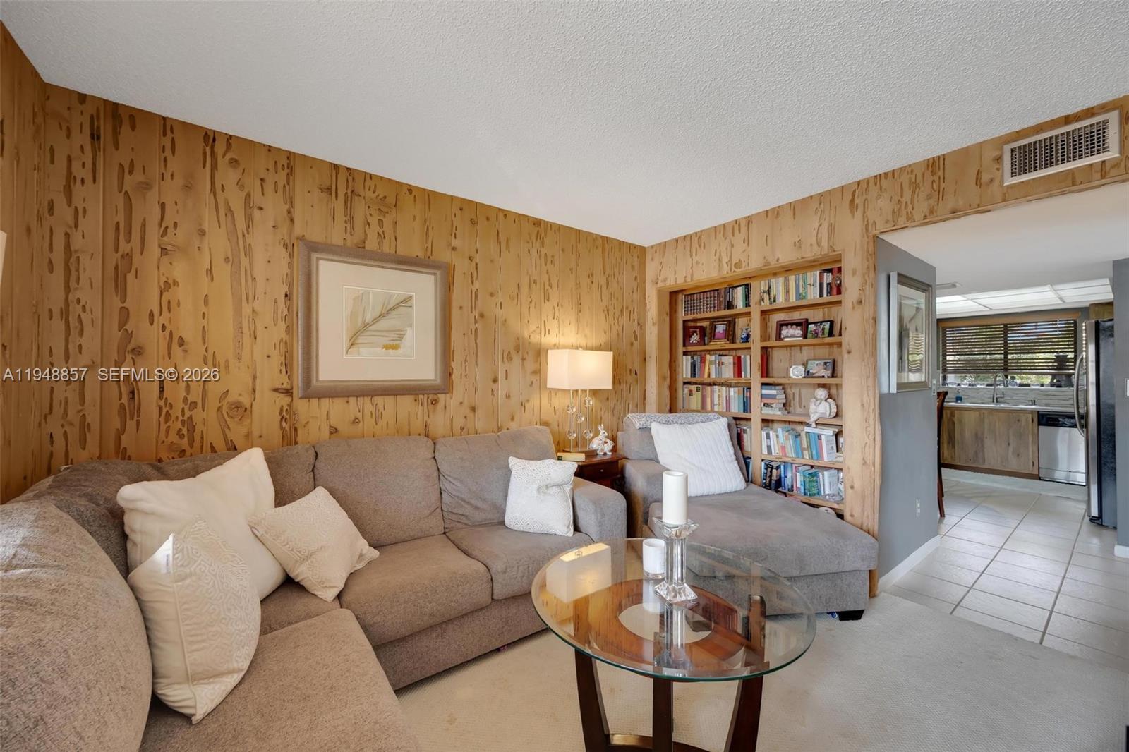 11769 Southwest 91st Terrace Miami, FL 33186 - Photo 9 of 33 a living room with furniture and a bookshelf