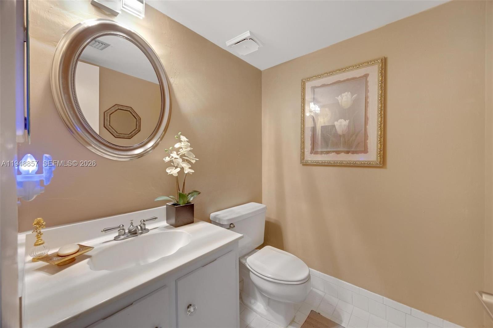 11769 Southwest 91st Terrace Miami, FL 33186 - Photo 10 of 33 a bathroom with a toilet a sink and a mirror