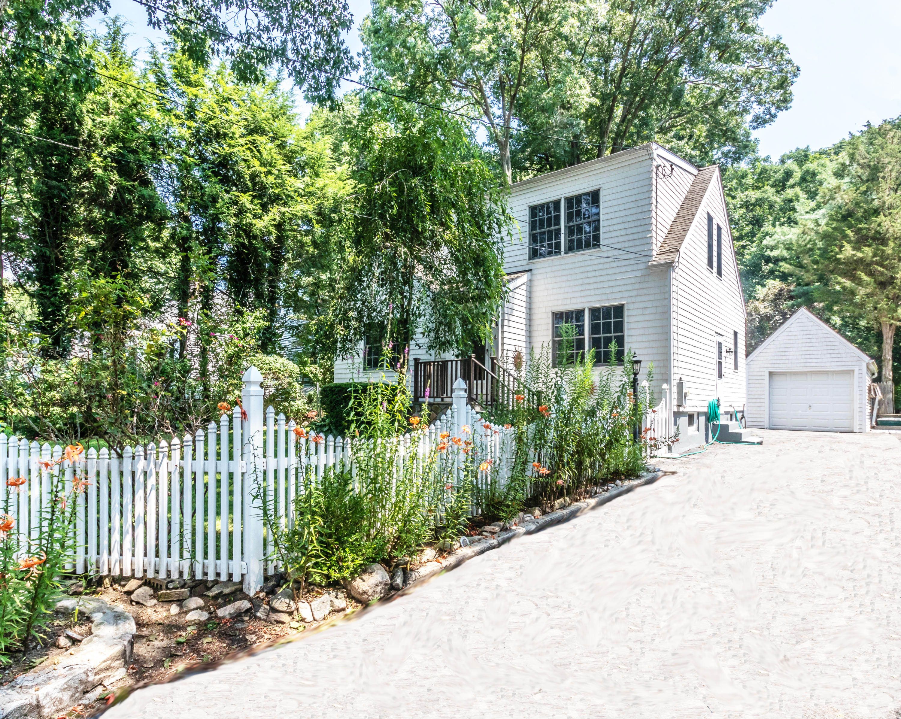 4 Moore Street Darien, CT 06820 - Photo 1 of 30 a front view of a house with a garden