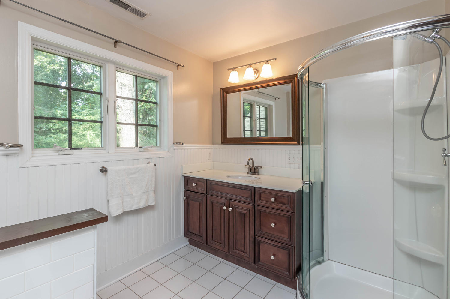 4 Moore Street Darien, CT 06820 - Photo 23 of 30 a bathroom with a toilet a sink a mirror a window and vanity