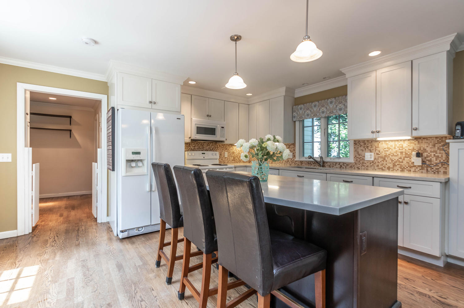 4 Moore Street Darien, CT 06820 - Photo 8 of 30 a kitchen with stainless steel appliances granite countertop a dining table chairs refrigerator and sink