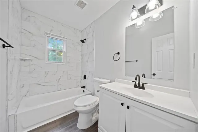 a bathroom with a sink a toilet and a bathtub