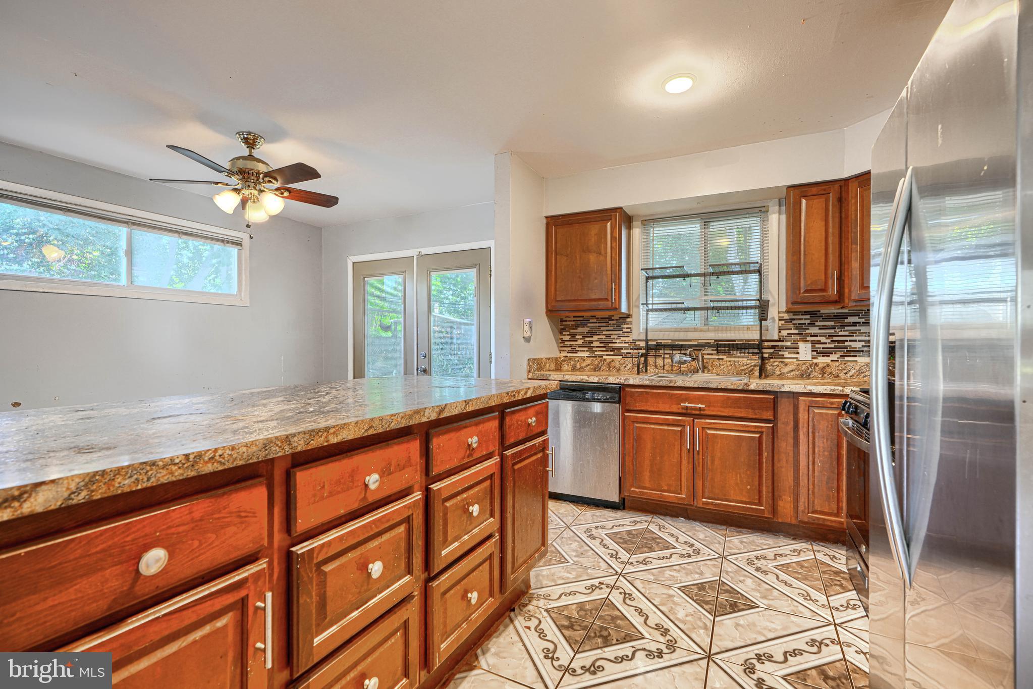 9706 Liberty Road Randallstown, MD 21133 - Photo 19 of 43 a kitchen with granite countertop stainless steel appliances a sink stove and refrigerator