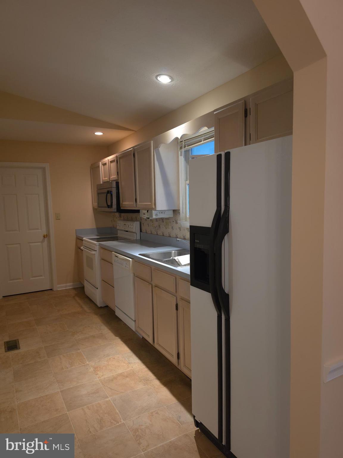 142 Braddock Boulevard Inwood, WV 25428 - Photo 11 of 36 a kitchen with a refrigerator and a sink