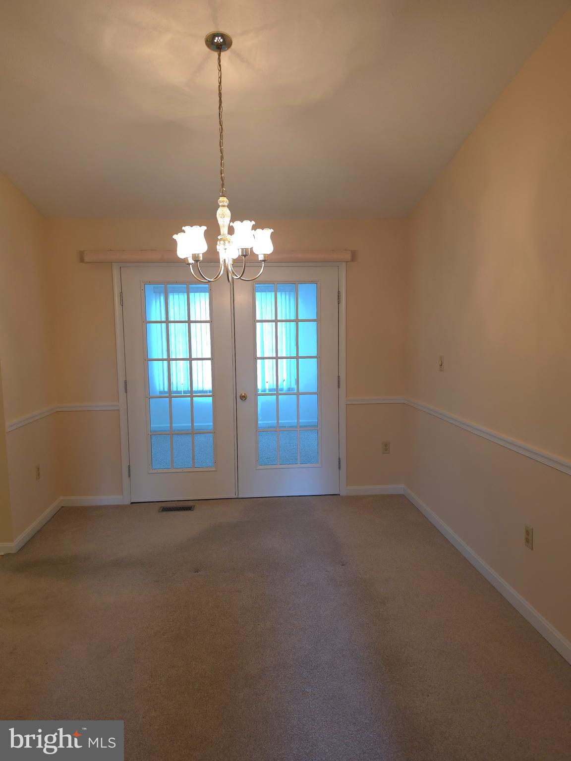 142 Braddock Boulevard Inwood, WV 25428 - Photo 15 of 36 a view of a room with windows and chandelier