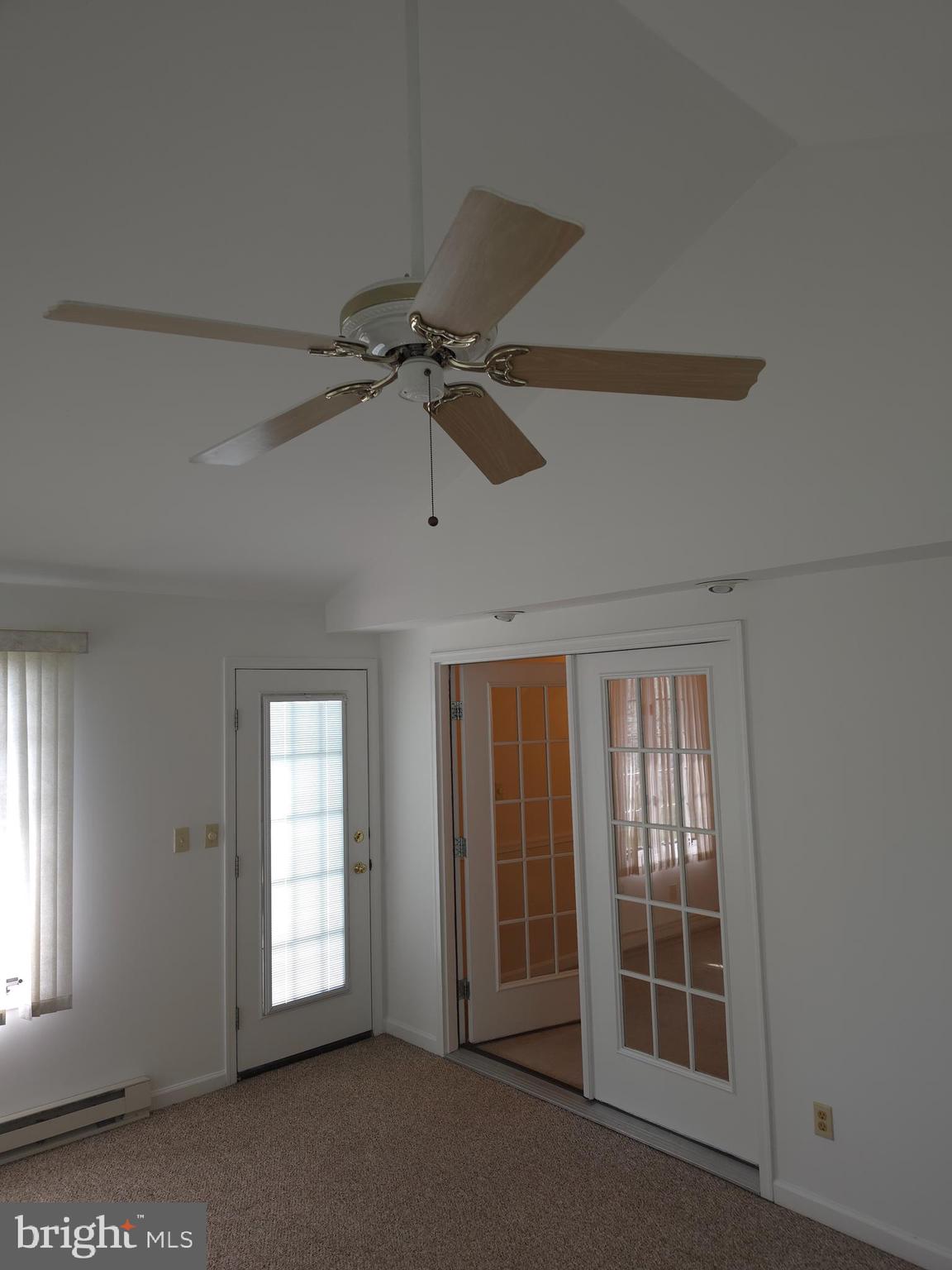 142 Braddock Boulevard Inwood, WV 25428 - Photo 17 of 36 an empty room with windows and fan