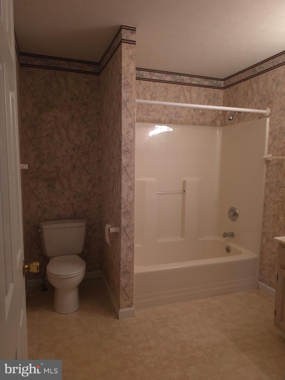 142 Braddock Boulevard Inwood, WV 25428 - Photo 20 of 36 a bathroom with a shower and a toilet